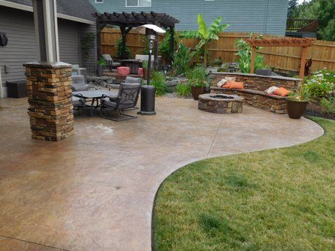 There is a fire pit in the middle of the backyard.