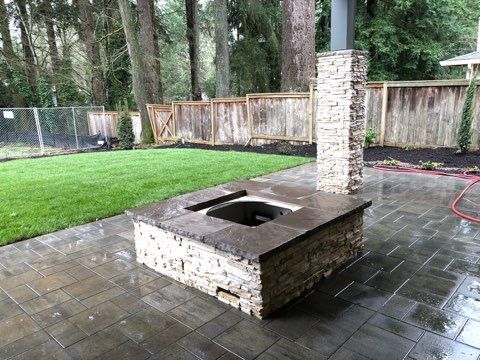 There is a fire pit in the middle of the backyard.