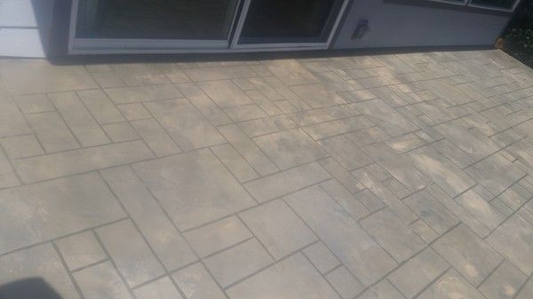 A brick floor with a sliding glass door in the background.