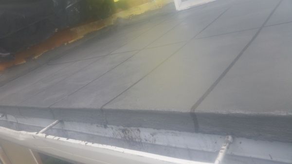 A close up of a roof with a gutter on it.