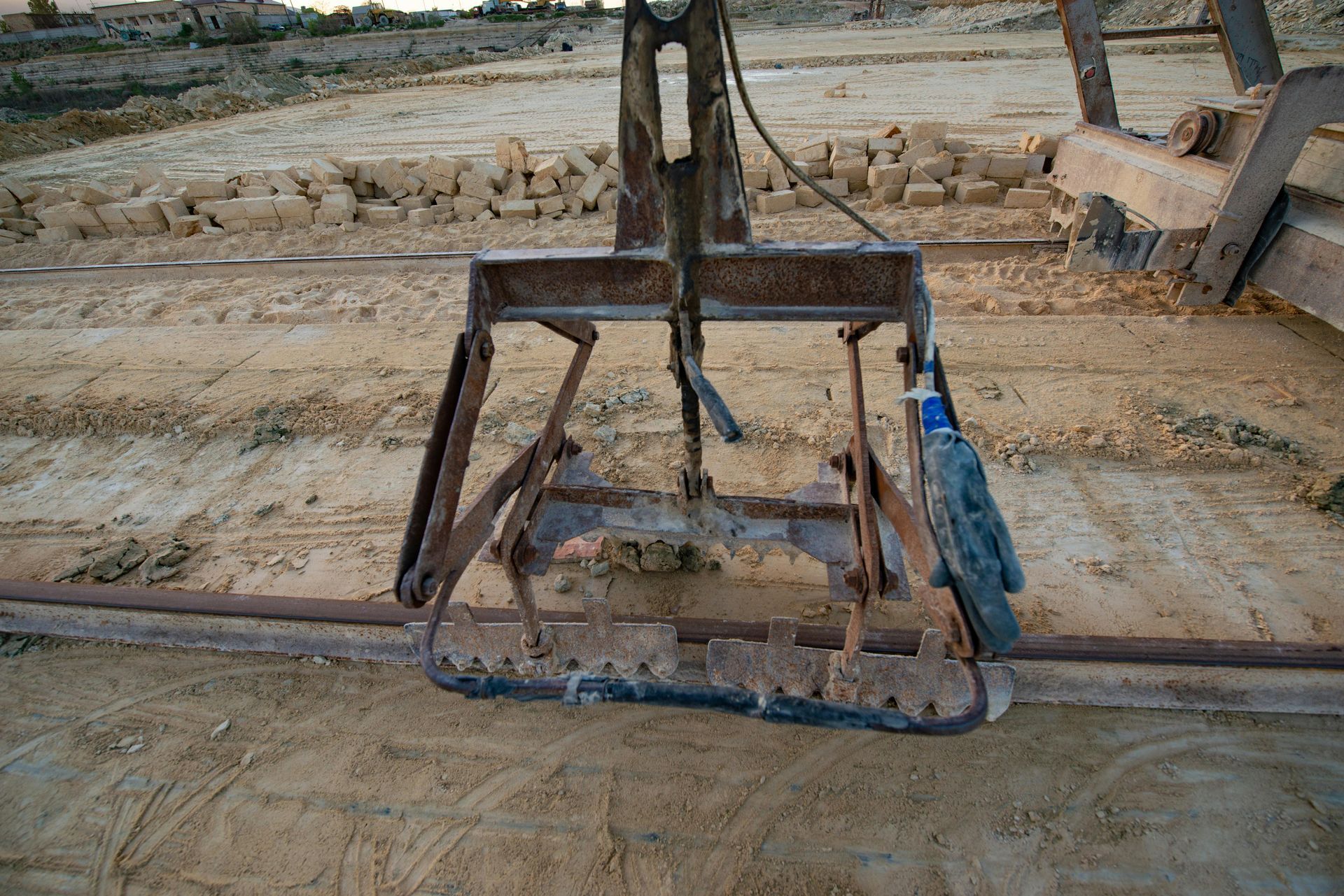 A piece of metal is sitting on top of a pile of dirt.