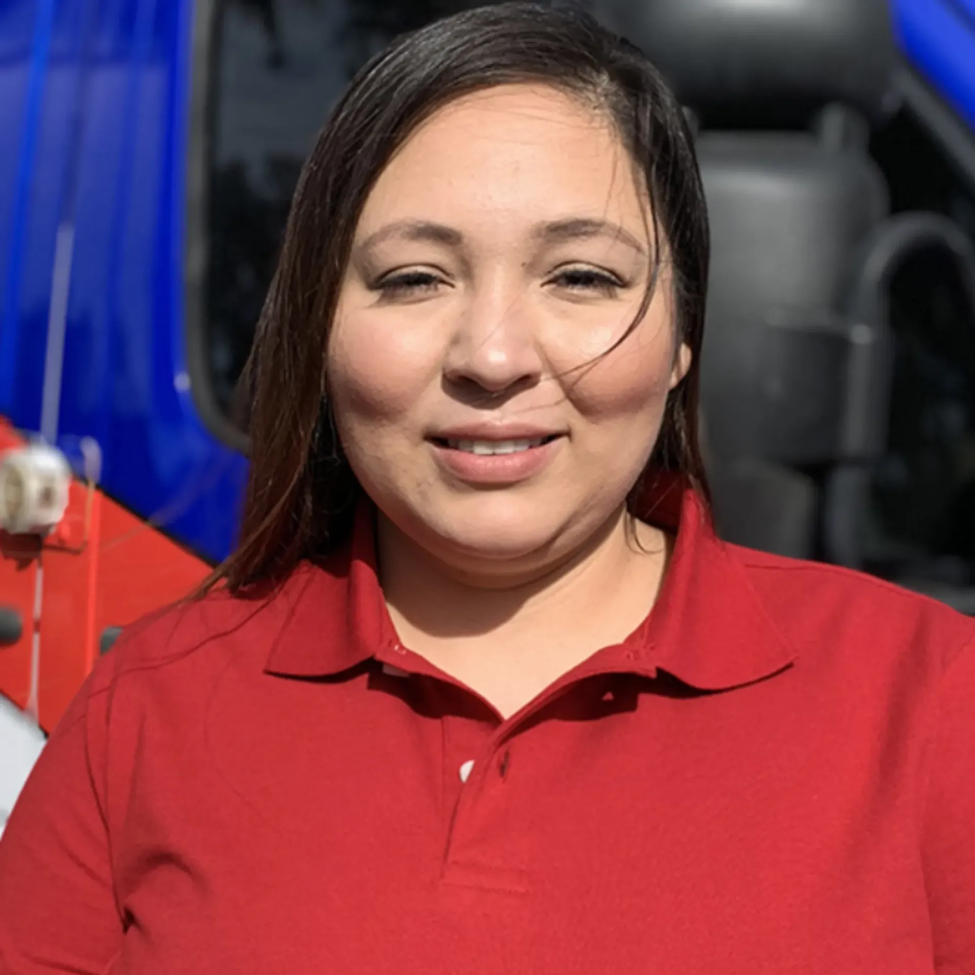 Ted & Bros Plumbing | woman in a red shirt is standing in front of a blue truck.
