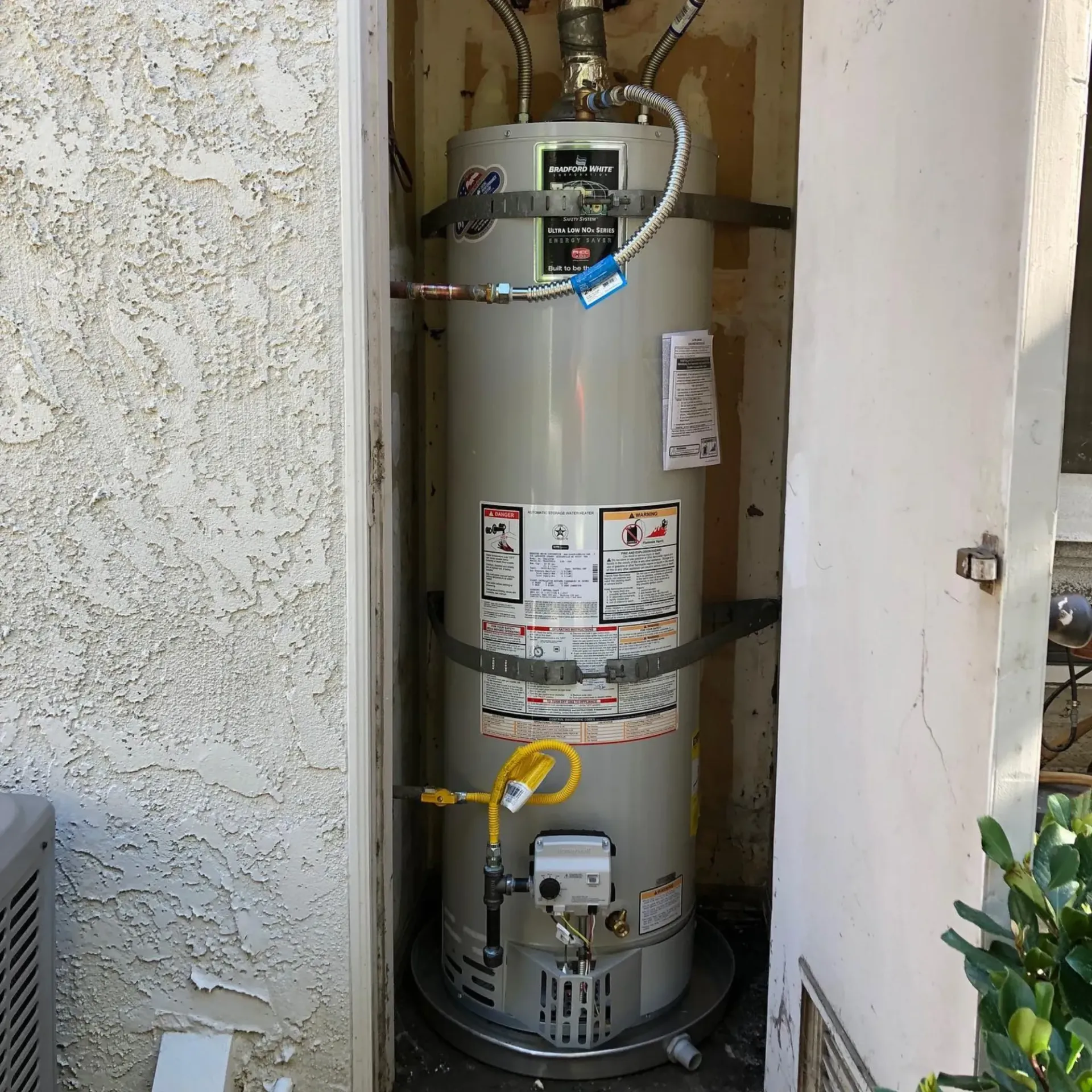 Ted & Bros Plumbing | water heater is sitting outside of a building
