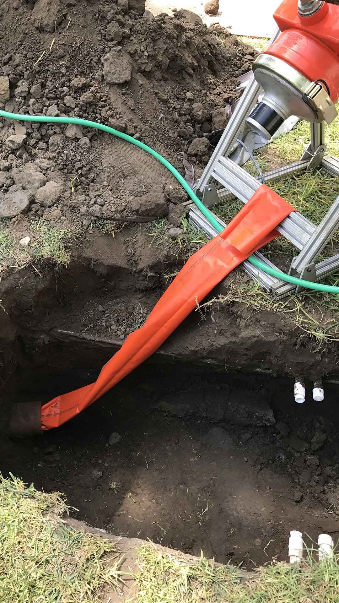 Ted & Bros Plumbing | fire hydrant is being installed in a hole in the ground.