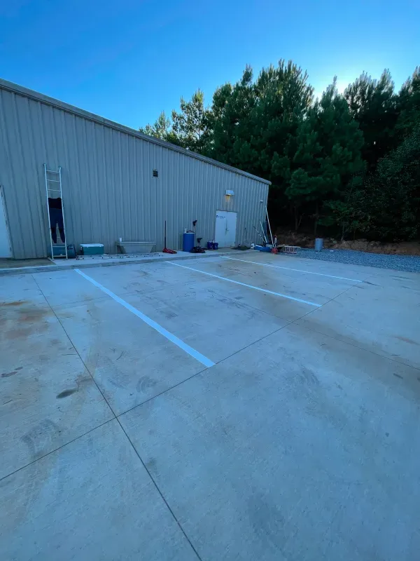 A large building with a lot of parking spaces in front of it.