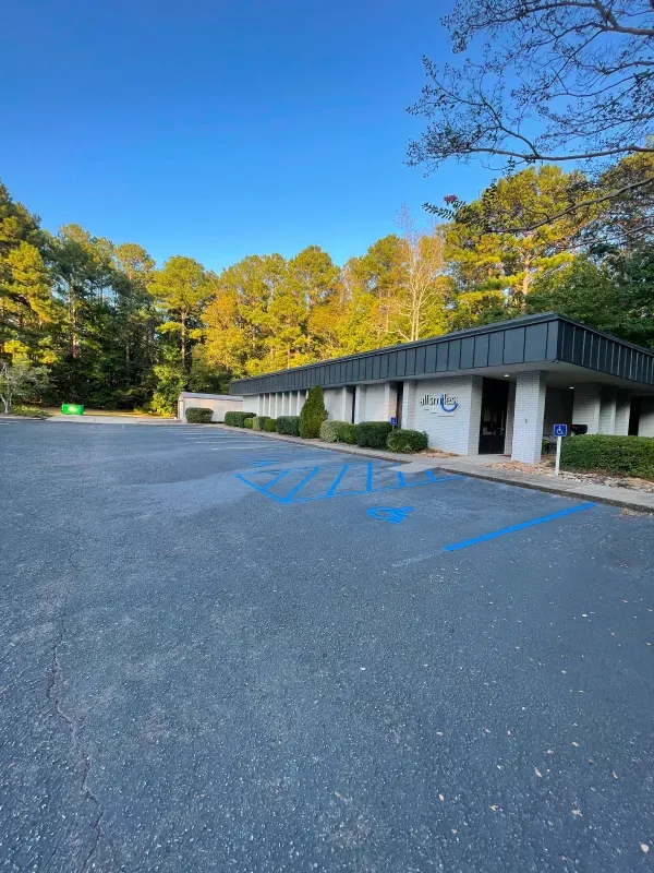 A building with a handicapped parking spot in front of it