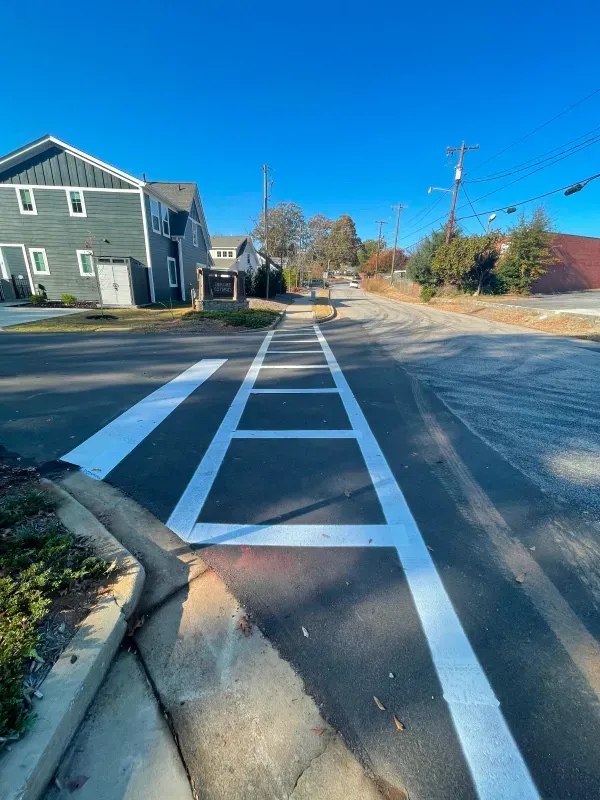 A row of white lines painted on the side of a road.
