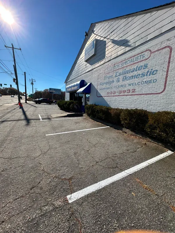There is a parking lot in front of a building.
