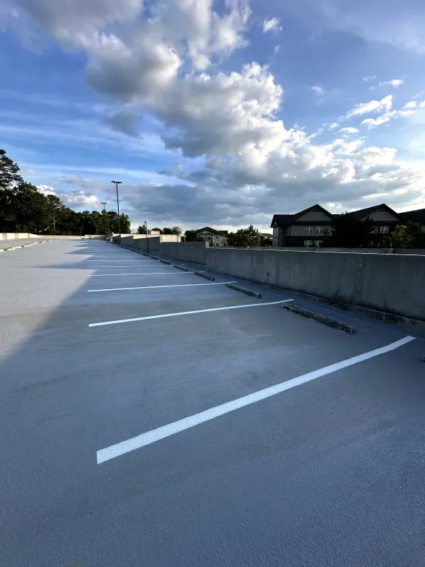 An empty parking lot with a blue sky in the background