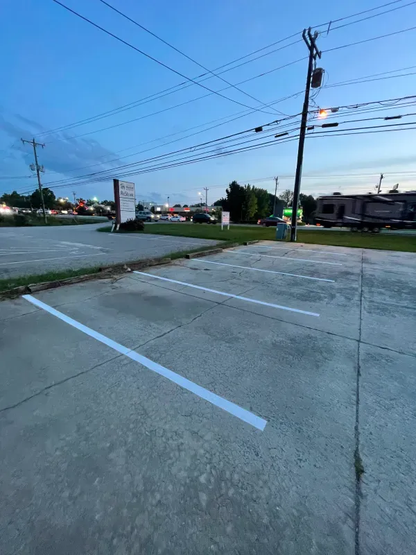 A parking lot with white lines on the side of it.
