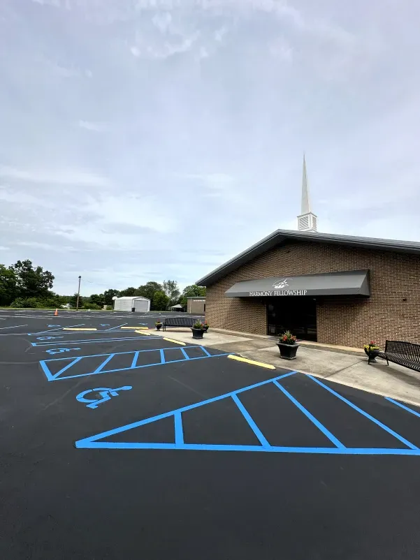 A church with a handicapped parking spot in front of it.