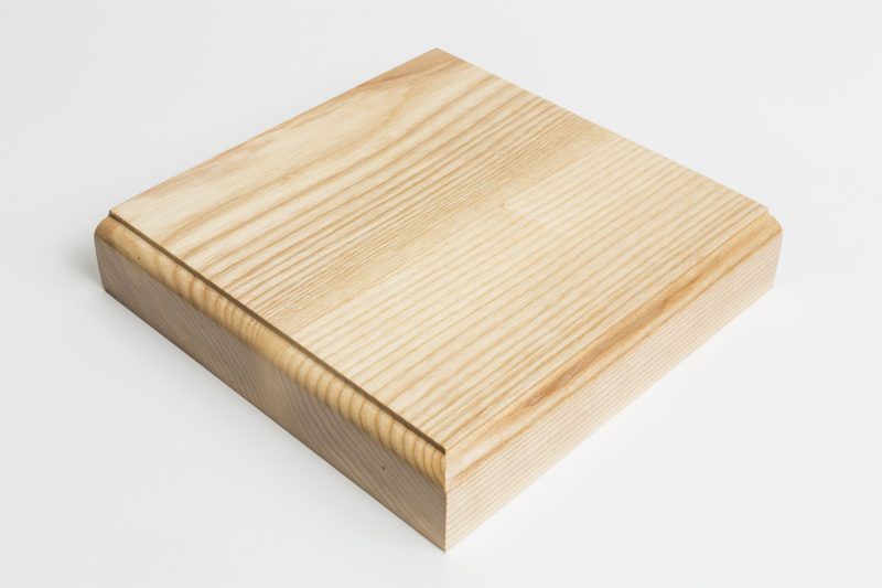 A piece of wood is sitting on a white surface.