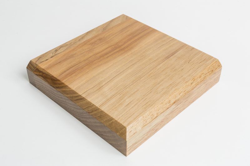 A piece of wood is sitting on a white surface.