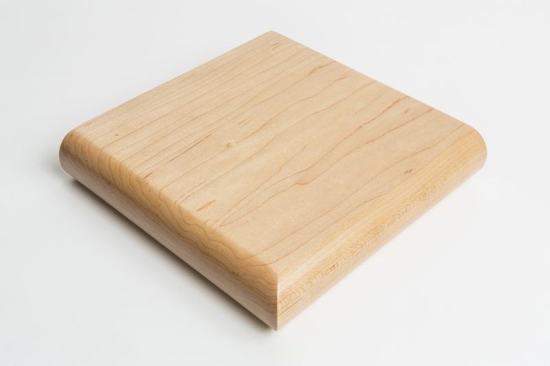 A piece of wood is sitting on a white surface.