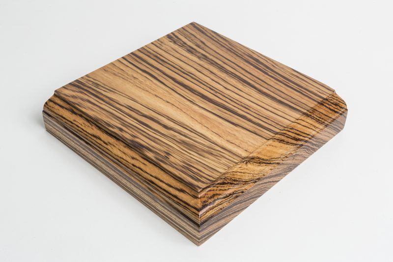 A piece of wood is sitting on a white surface.