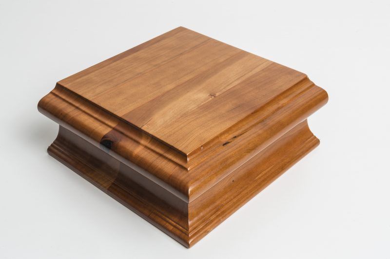 A wooden box is sitting on a white surface