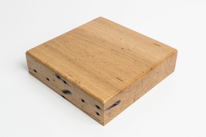 A piece of wood is sitting on a white surface.