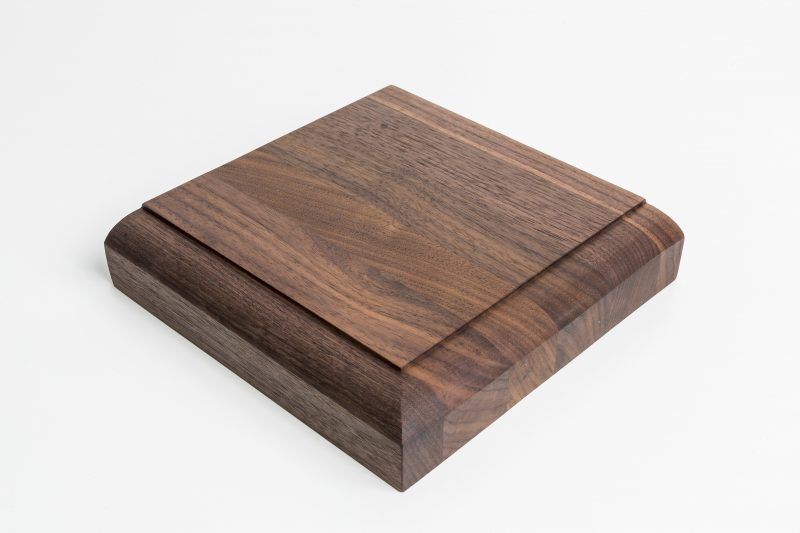 A piece of wood is sitting on top of a white surface.