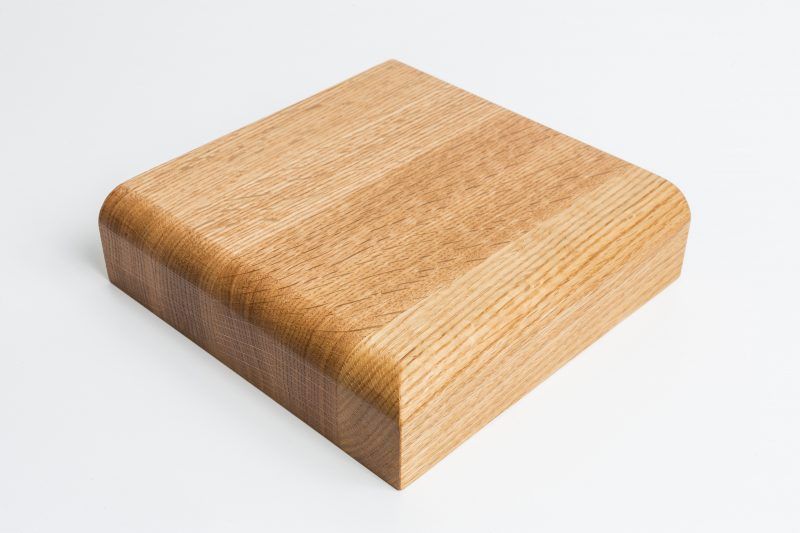 A piece of wood is sitting on a white surface.