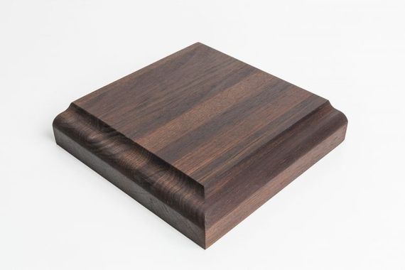 Dark wood-grain square display base with a beveled edge on a white background