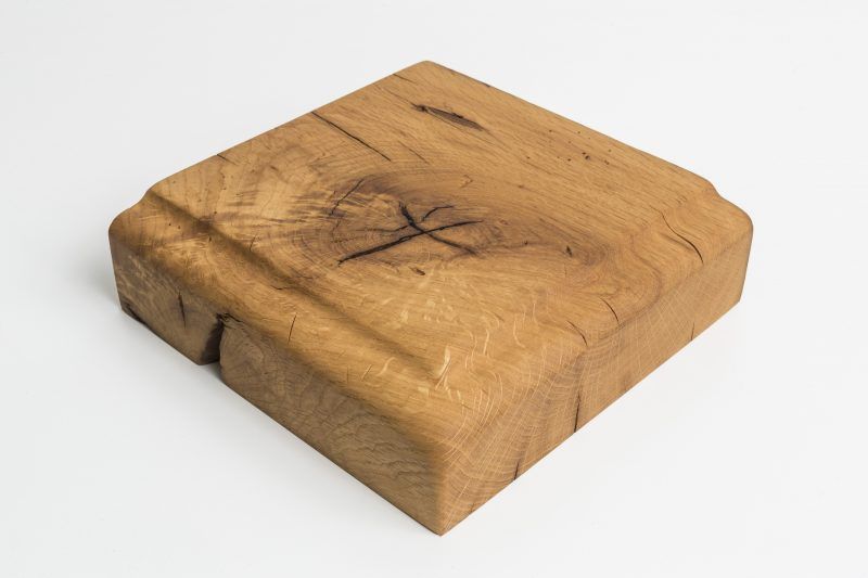 A piece of wood is sitting on a white surface.