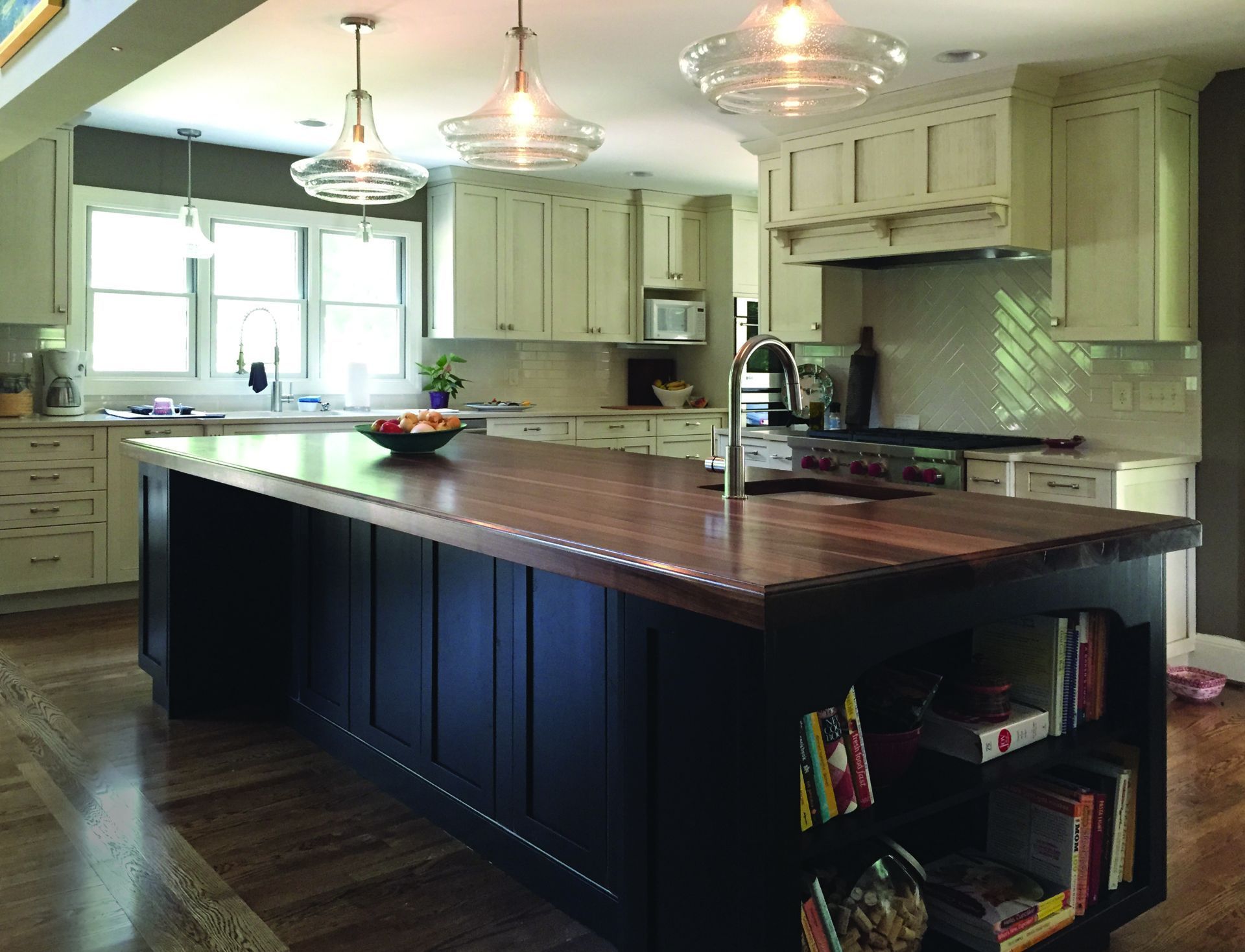 A kitchen with white cabinets and a large island