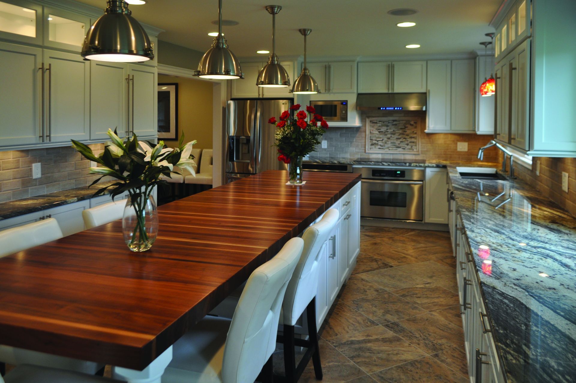 A kitchen with a long wooden table and chairs