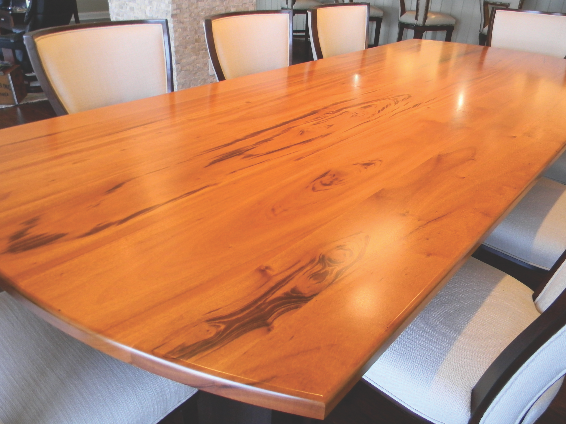 A wooden table with white chairs around it