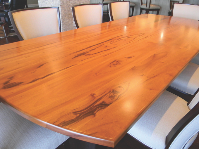 A wooden table with white chairs around it