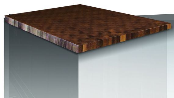 Close-up of a dark wood countertop on a gray cabinet or island with a beveled edge