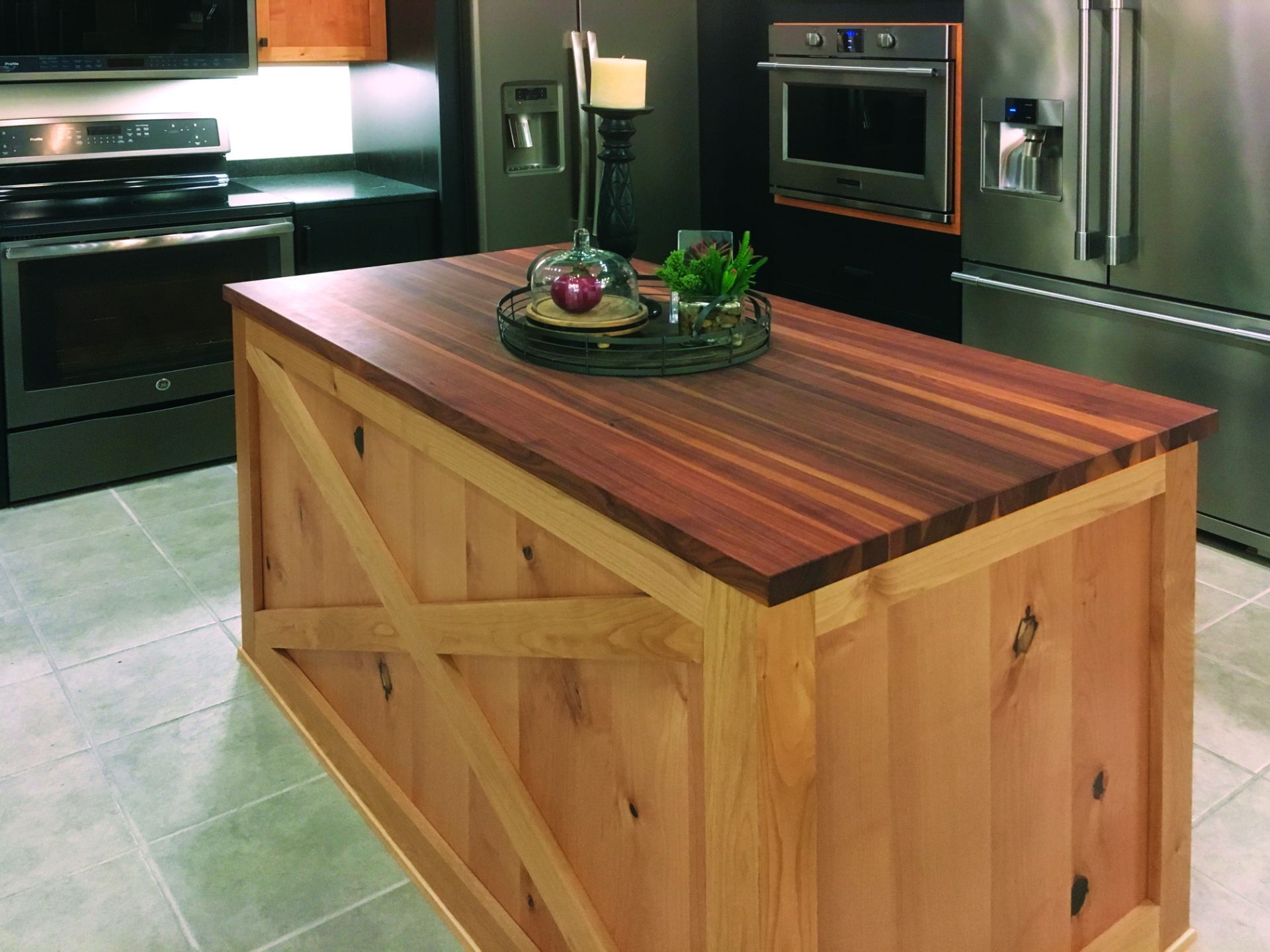 A kitchen with stainless steel appliances and a wooden island