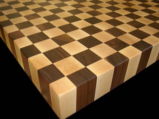 A wooden cutting board with a checkered pattern