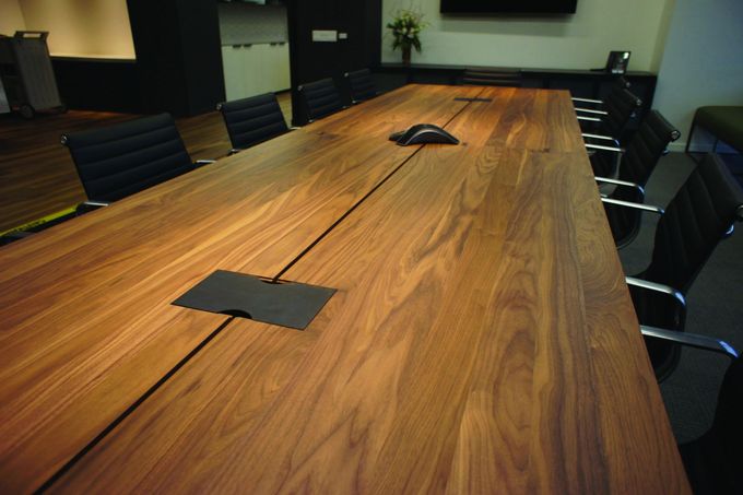 A conference room with a long wooden table and chairs