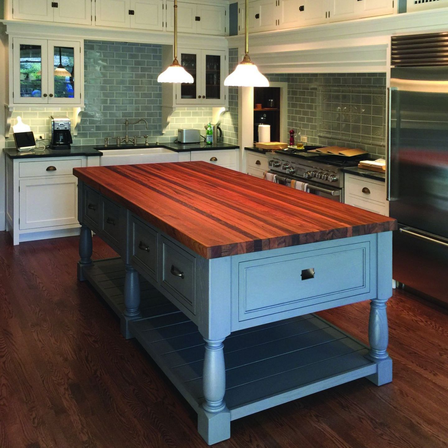 A kitchen with a large wooden table in the middle