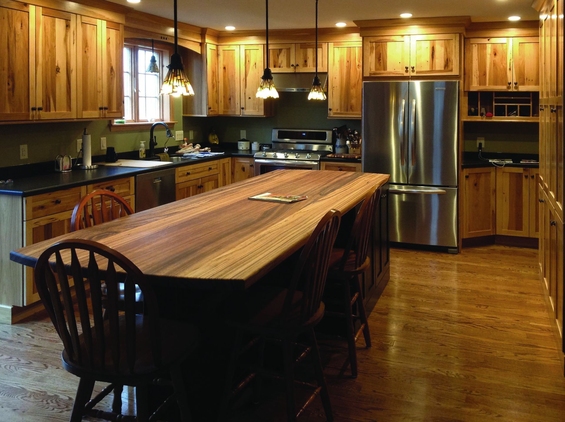 A kitchen with wooden cabinets and stainless steel appliances