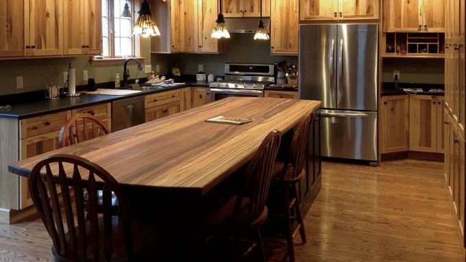 A kitchen with stainless steel appliances and wooden cabinets