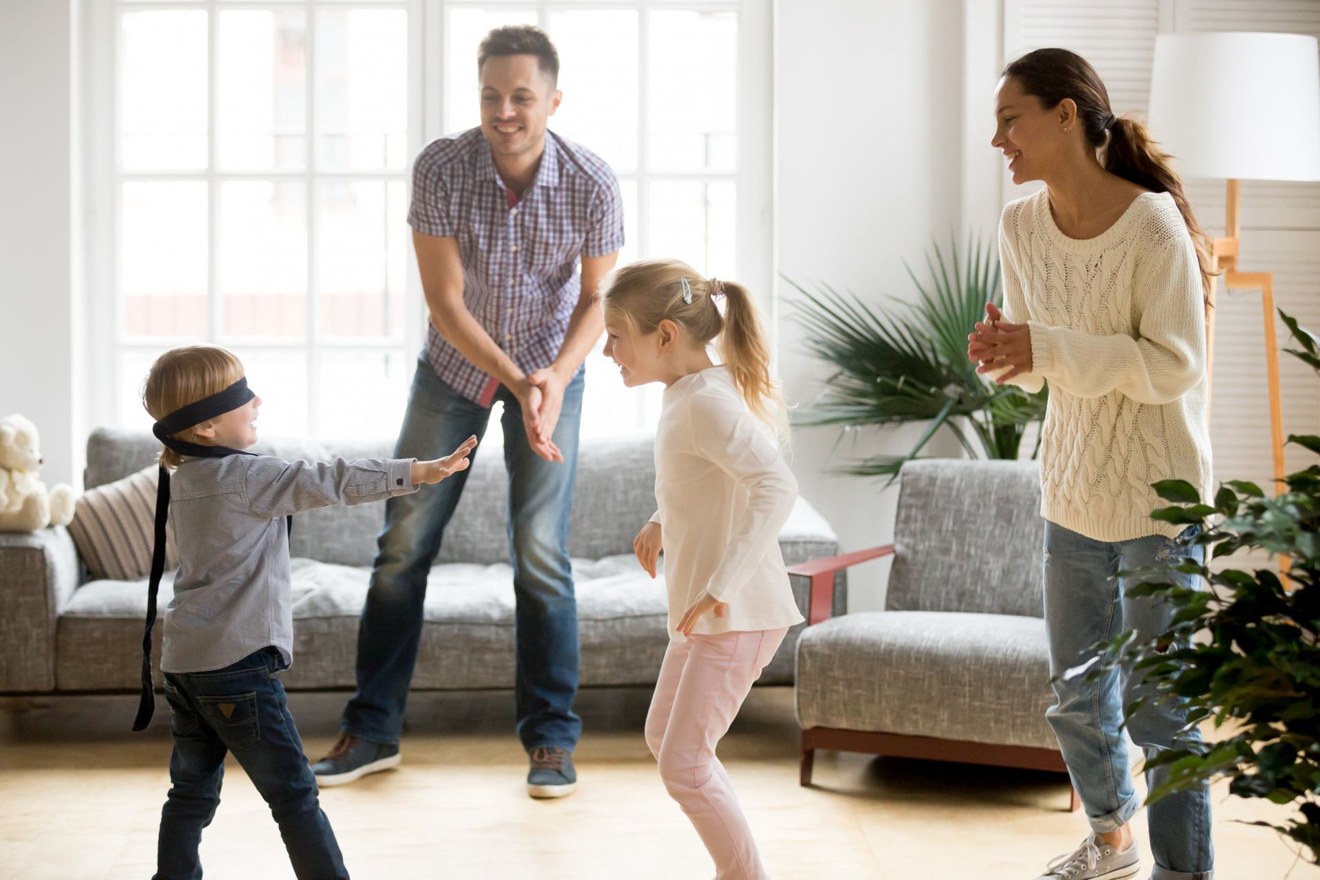 A family is playing a game in the living room.