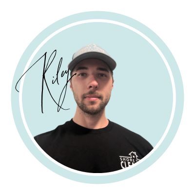 Man in black shirt and cap inside a light blue circle. 