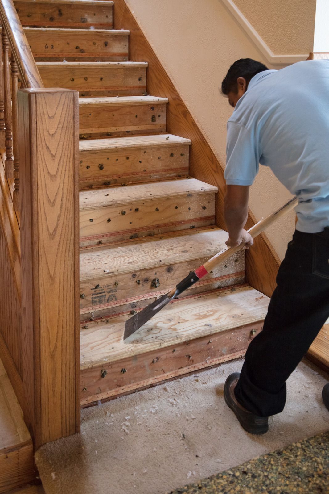 A man is working on a kitchen in a house under construction