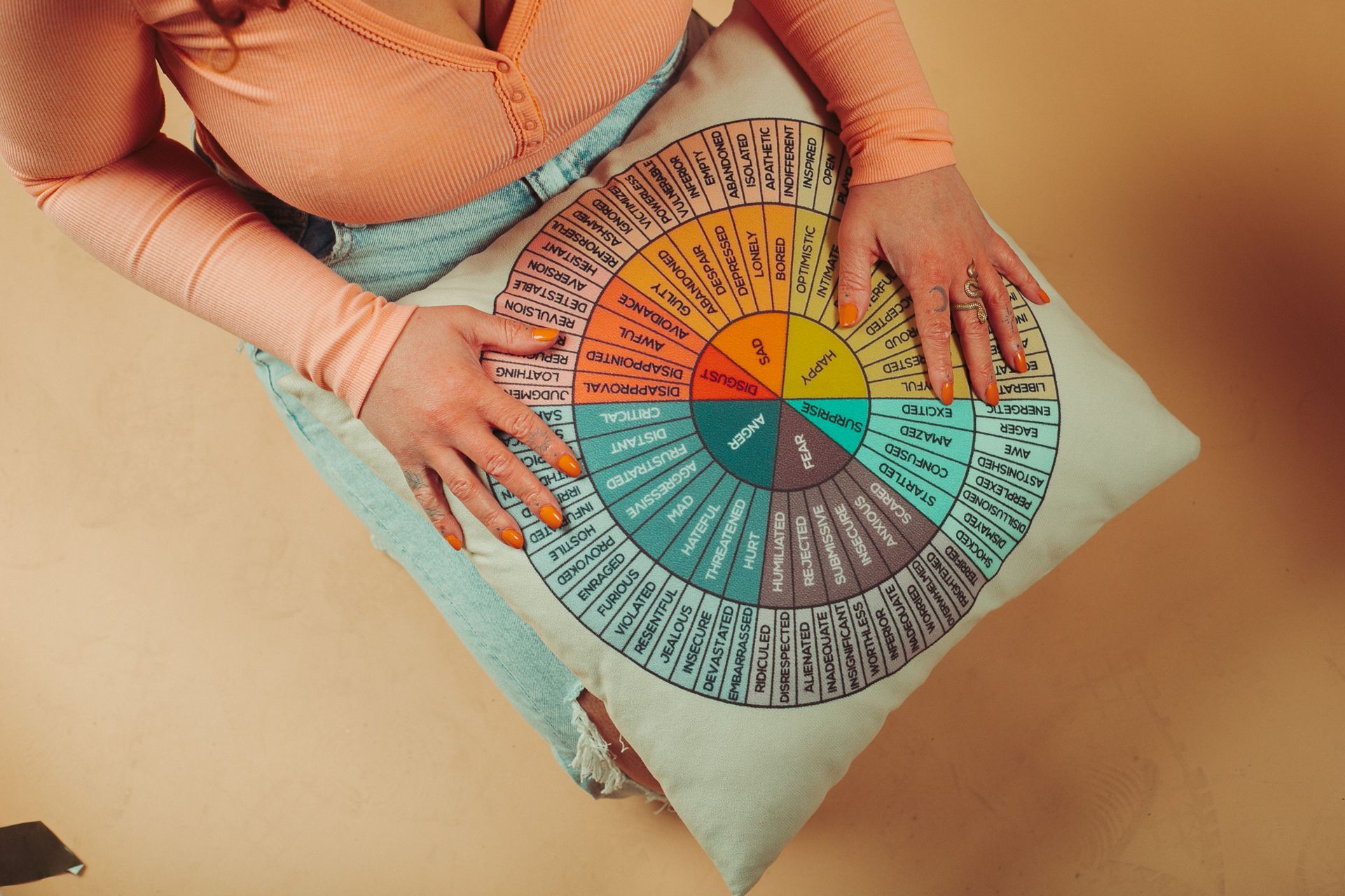 A woman is sitting on a pillow with a wheel on it.
