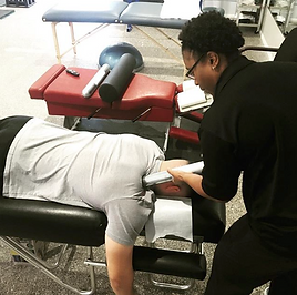 Person receiving neck treatment from Dr. Natasha Williams for B2Y in a therapy setting.