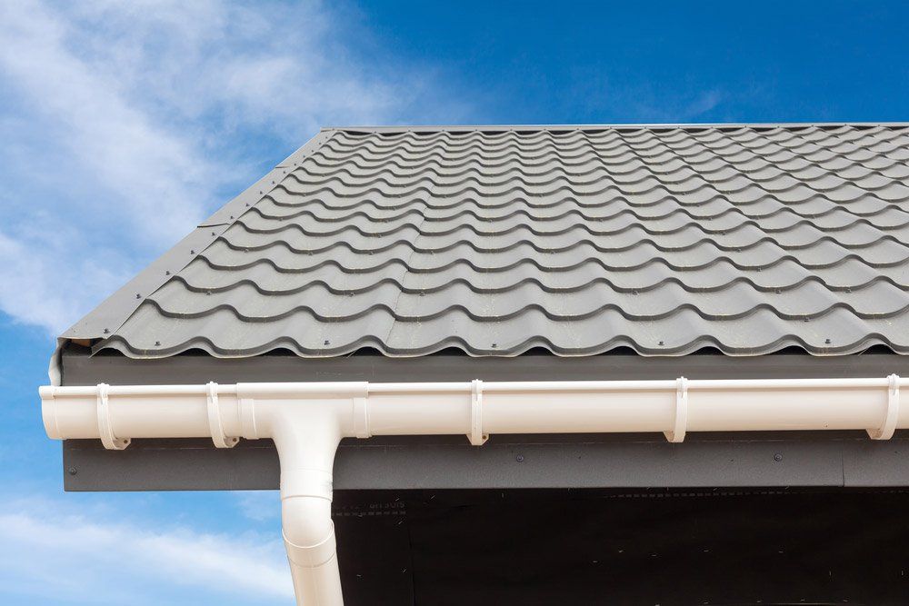 New Gray Metal Tile Roof With White Rain Gutter — Roof Painting in Manning Valley, NSW