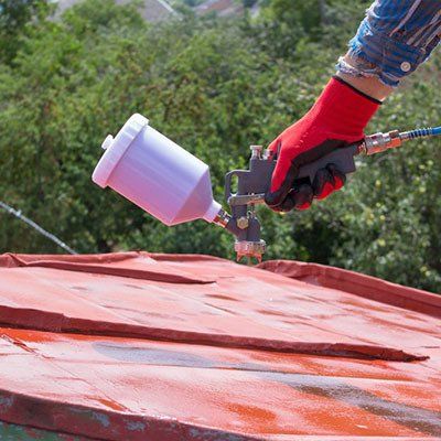 Spray Gun Painting on Roof — Roofing Services in the Manning Valley, NSW