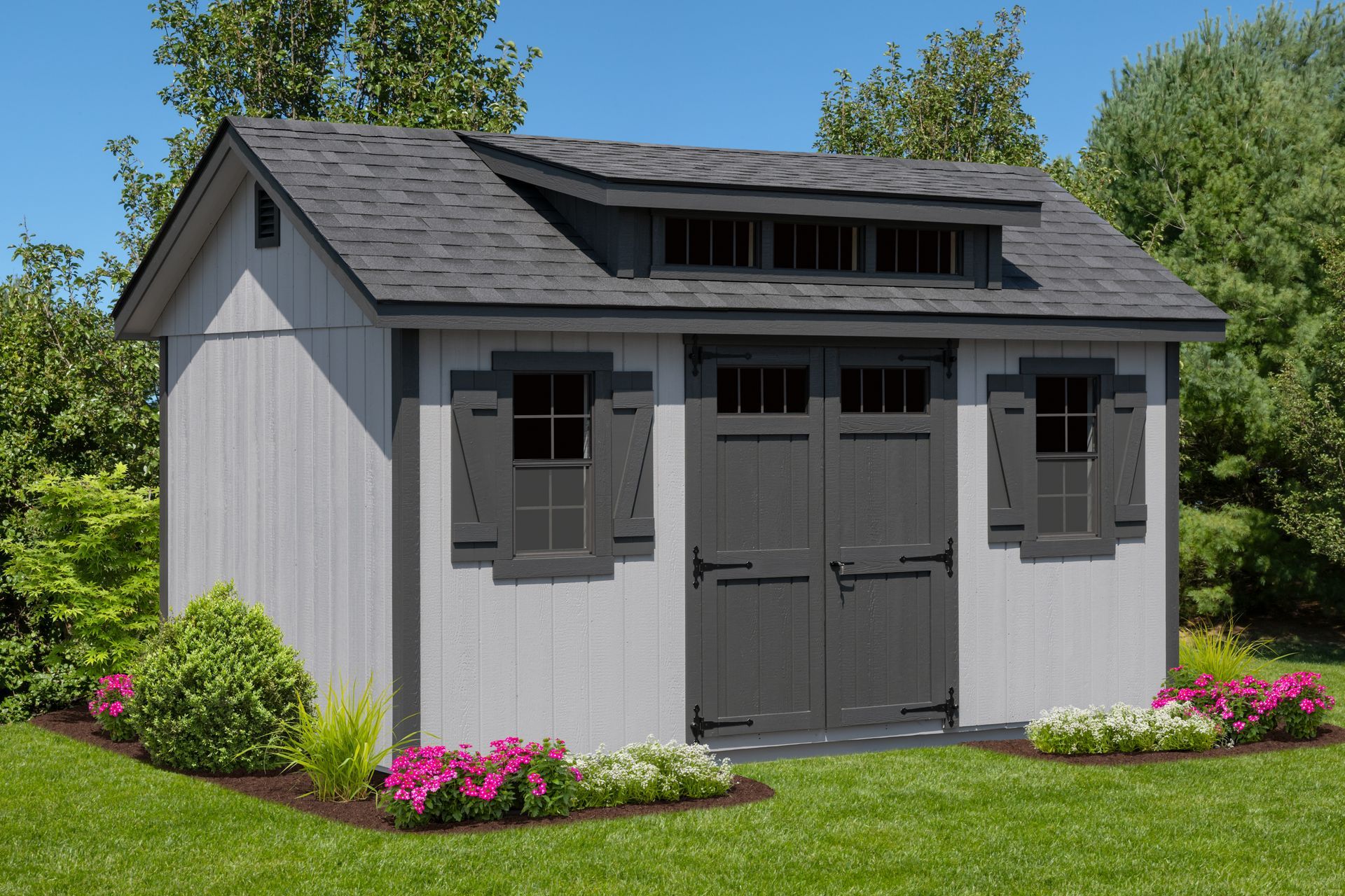 Gray storage shed with dark gray trim and doors, two windows, and dormer.