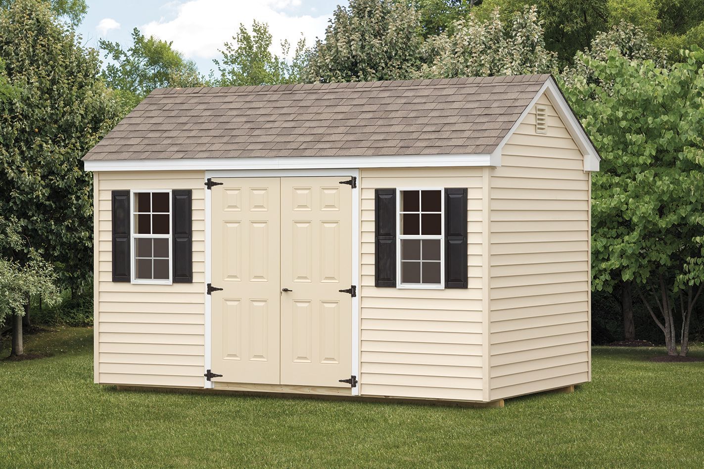 Beige shed with brown roof, two windows with black shutters, and double doors; set in a yard.