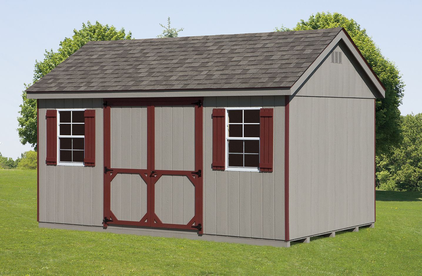 Gray shed with maroon trim, a dark roof, two windows, and double doors, set in a grassy yard.