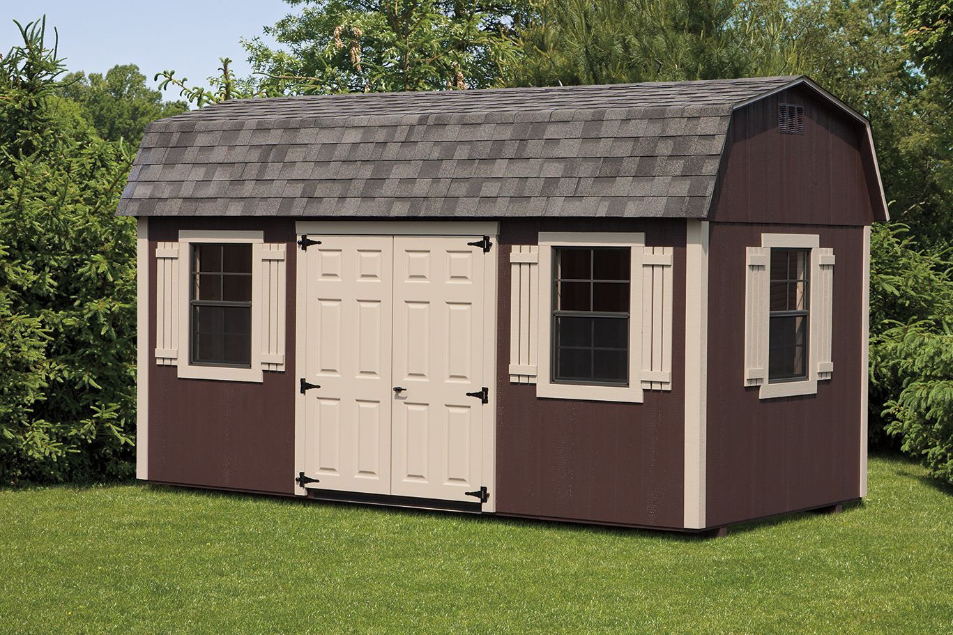Brown shed with a tan trim, double doors, and windows, on a green lawn.