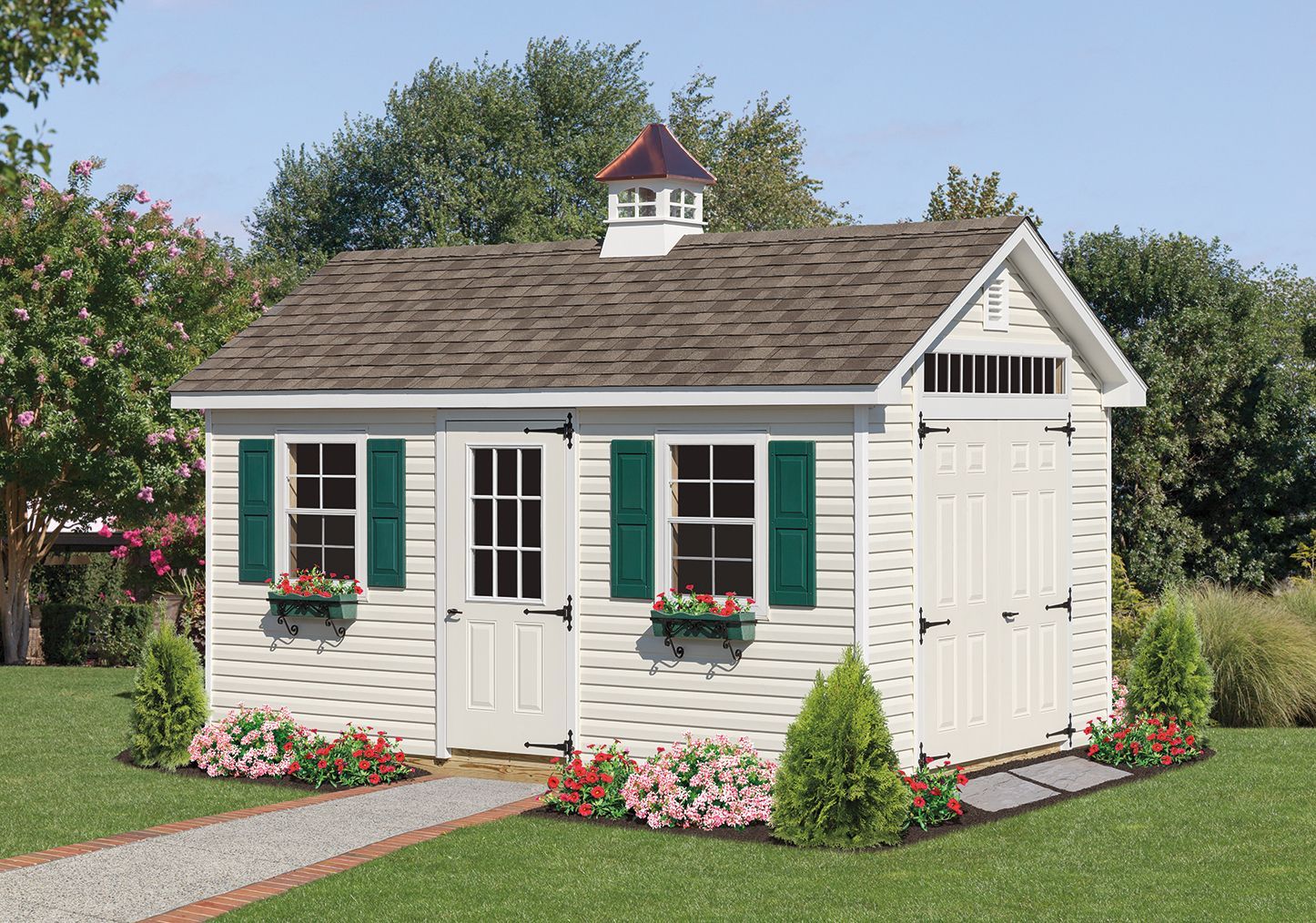 White shed with green shutters, a gravel path, and flower beds.