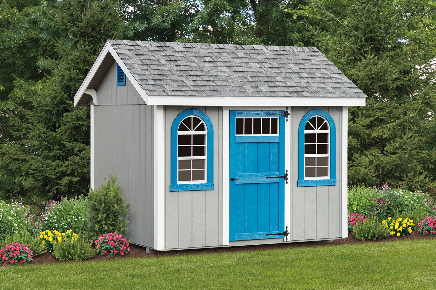 Gray shed with blue door, arched windows, gray roof, and white trim, in a grassy yard.