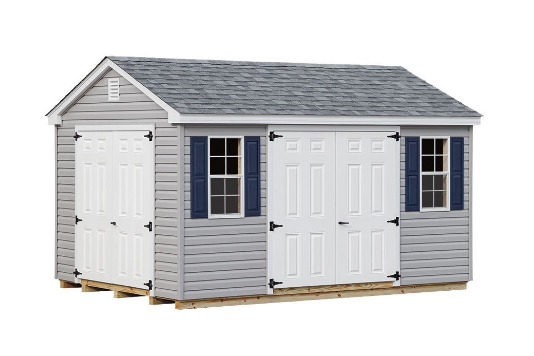 Gray shed with white doors and blue shutters.